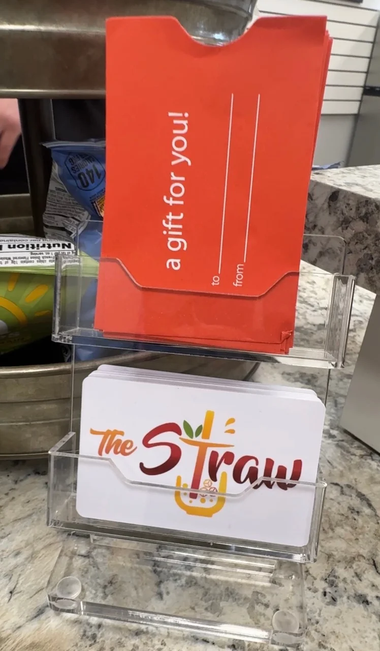 The Straw gift cards and red gift envelopes available at the register