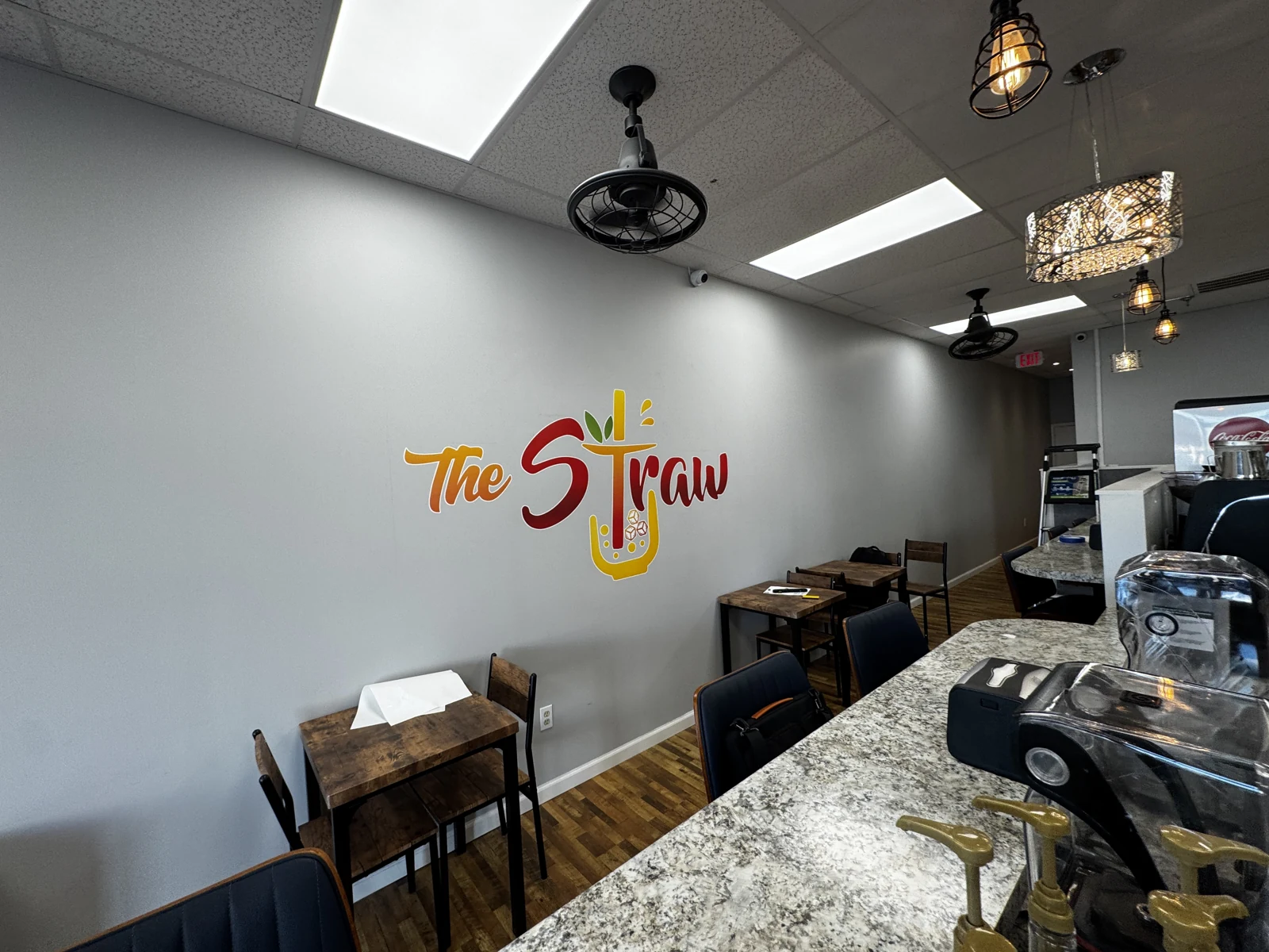 Tables and The Straw logo inside the café